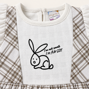 Close-up of bunny graphic on white chest panel of taupe checked outfit