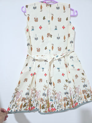 Original back view of ivory botanical girls dress showing zipper, waist ties and border print