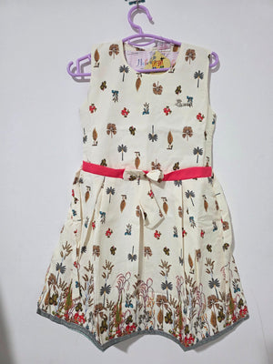 Original front view of ivory botanical girls dress with pink sash and border print