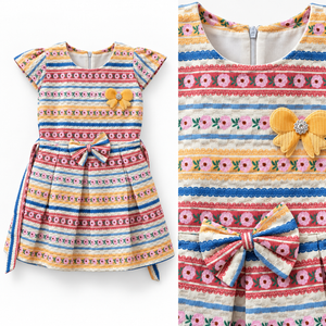Close-up detail of striped floral girls dress showing yellow applique and waist bow