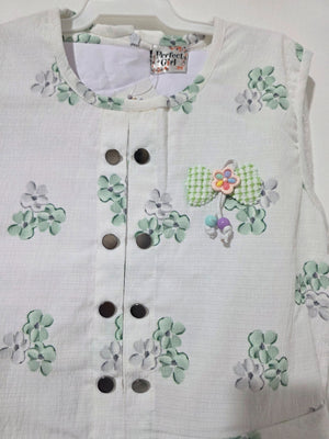 Close-up of Inaabia white and mint floral girls dress neckline, button placket and decorative chest detail