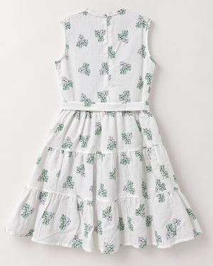 Studio back view of Inaabia white and mint green floral tiered girls dress