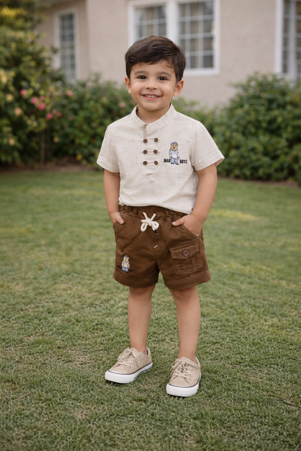 Boy wearing a beige short-sleeve shirt and brown cargo shorts two-piece set