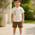 Toddler boy wearing a cream embroidered mandarin-collar shirt and brown shorts set