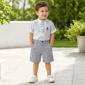 Young boy wearing a grey patterned mandarin-collar shirt and cargo shorts set