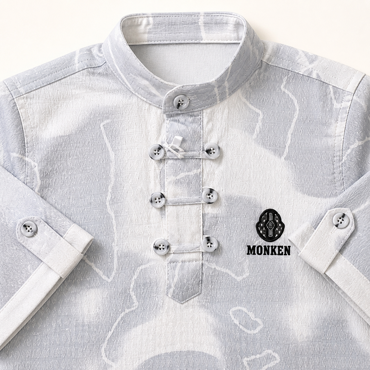 Close-up of boys grey patterned shirt collar and decorative button closures
