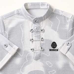 Close-up of boys grey patterned shirt collar and decorative button closures