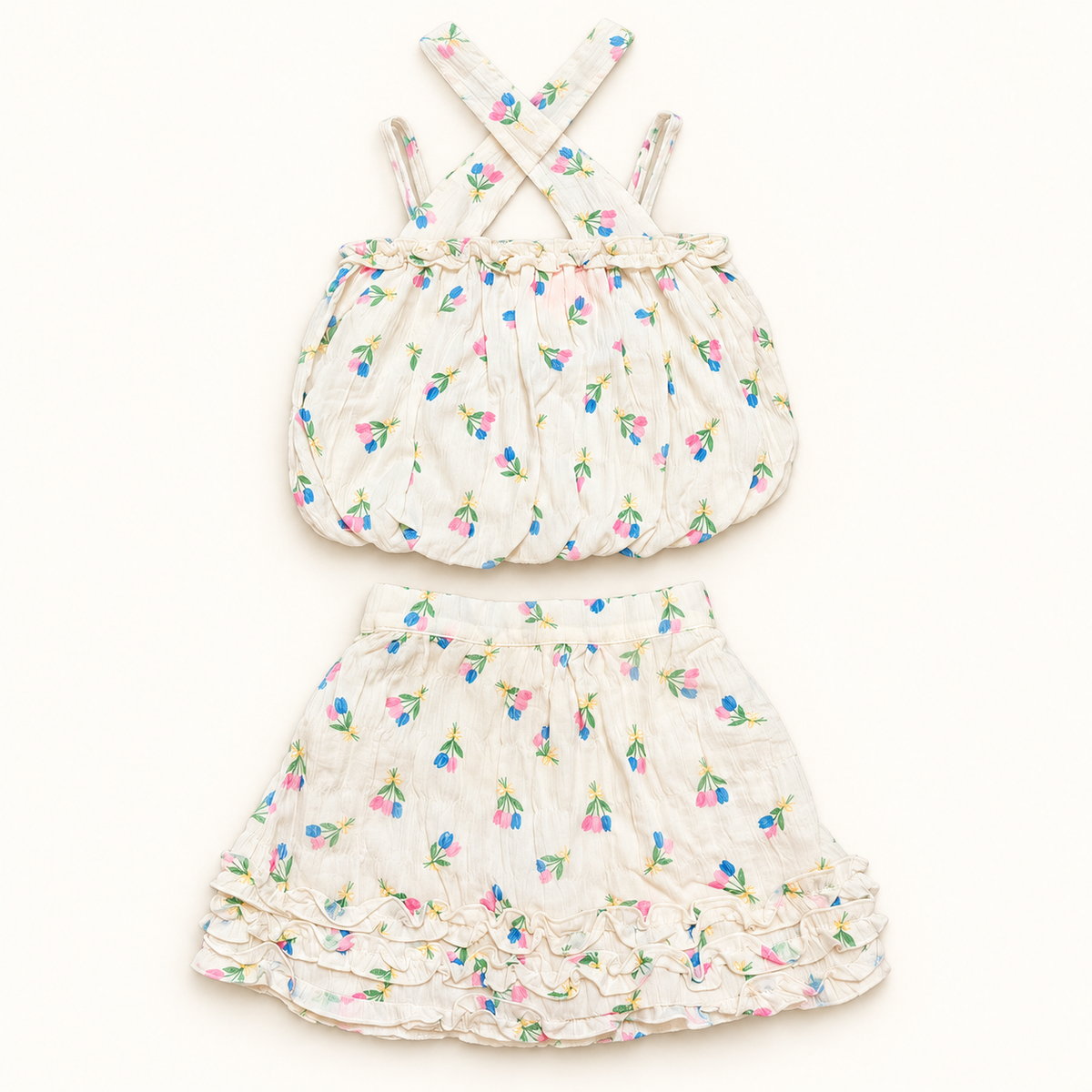 Ivory floral crossed-strap bubble top and matching ruffled skirt