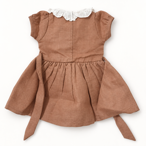 Brown baby dress back view with white ruffled collar and waist ties