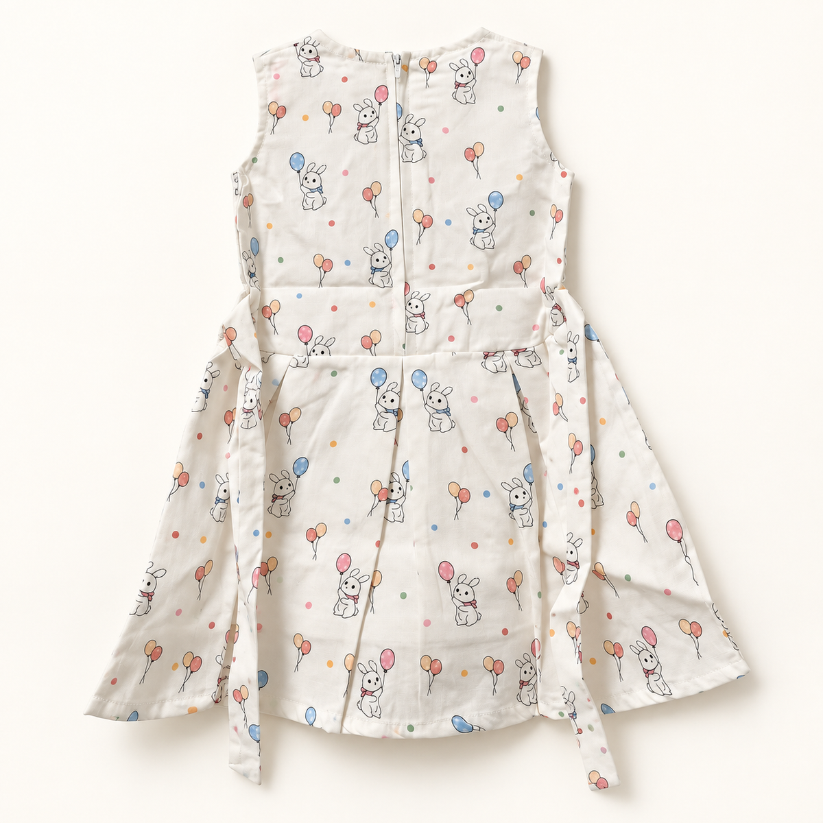 Back of ivory bunny and balloon dress showing zipper and waist ties