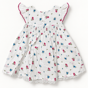 White floral baby dress back view showing two buttons and shirred waist