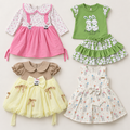 Inaabia 4-piece girls combo set flat lay with pink floral dress, green bunny set, ivory bunny dress and sage lemon party dress