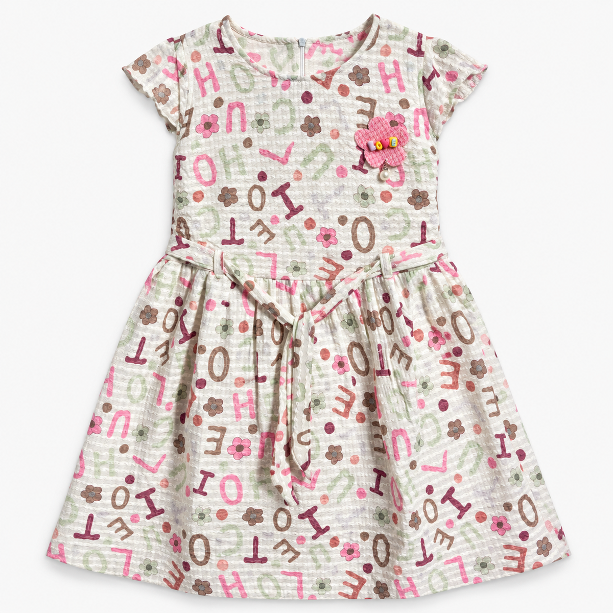 Front view of off-white alphabet and flower print girls dress with waist tie and pink LOVE applique