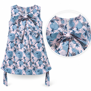Close-up detail of blue and pink floral girls dress showing oversized front bow