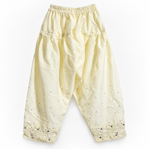 Matching cream trousers with silver cuffs