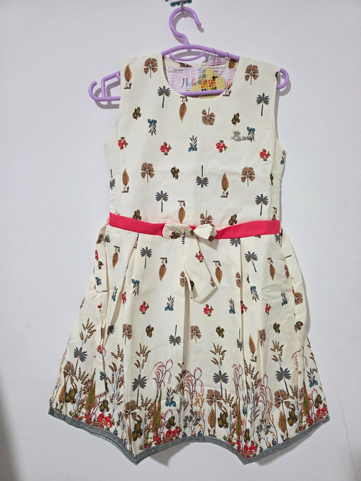 Original front view of ivory botanical girls dress with pink sash and border print