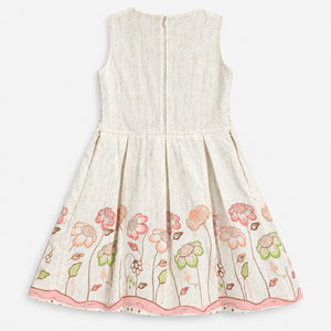 Back view of ivory sleeveless girls dress with back zipper and floral border hem