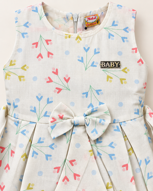 Close-up of ivory pastel sprig girls dress showing print, bow and chest detail