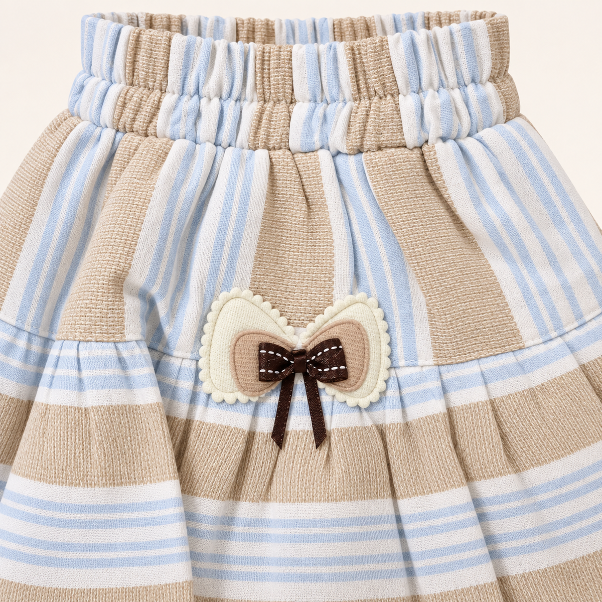Striped skirt fabric and bow detail