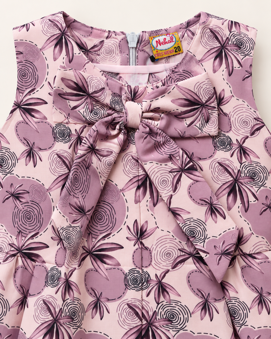 Close-up of dusty mauve floral girls dress showing oversized bow and print detail