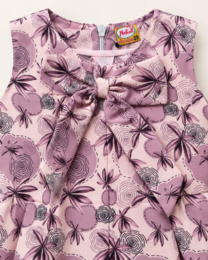 Close-up of dusty mauve floral girls dress showing oversized bow and print detail