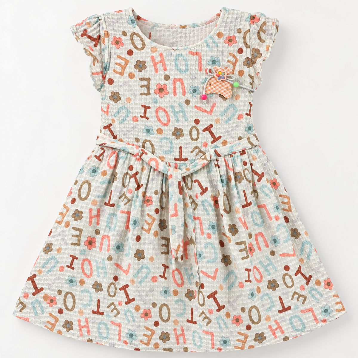 Front view of off-white textured alphabet and floral print girls dress with waist tie and pastel bead applique