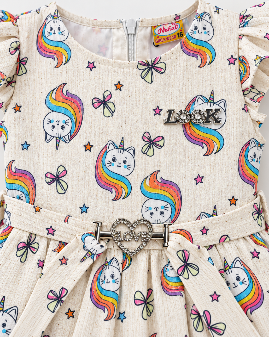 Close-up of cream rainbow cat girls dress showing LOOK chest detail, heart buckle, print and flutter sleeves